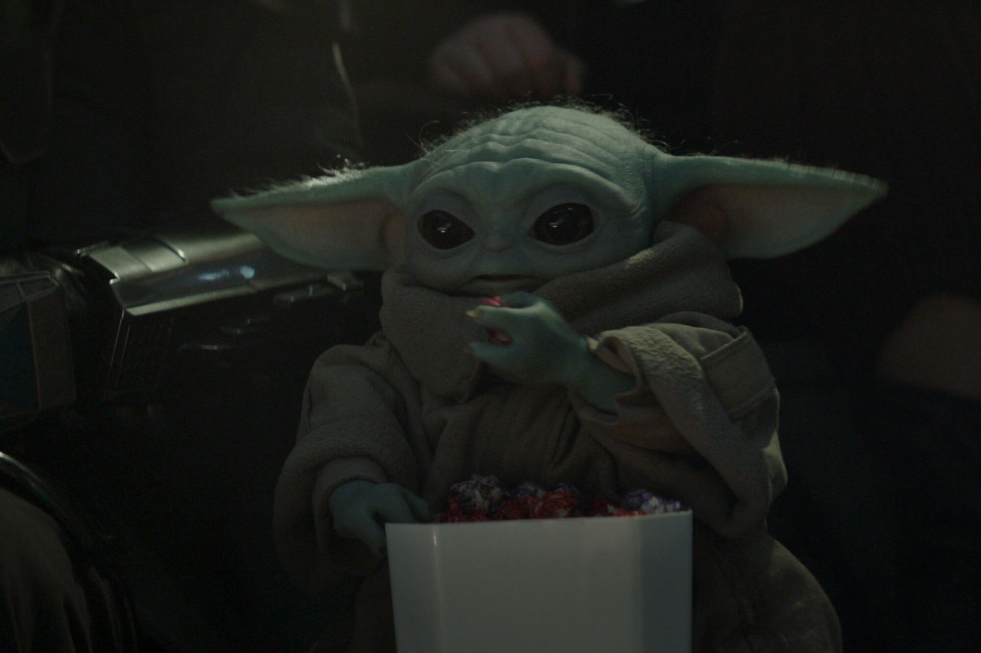 an alien creature eating a snack