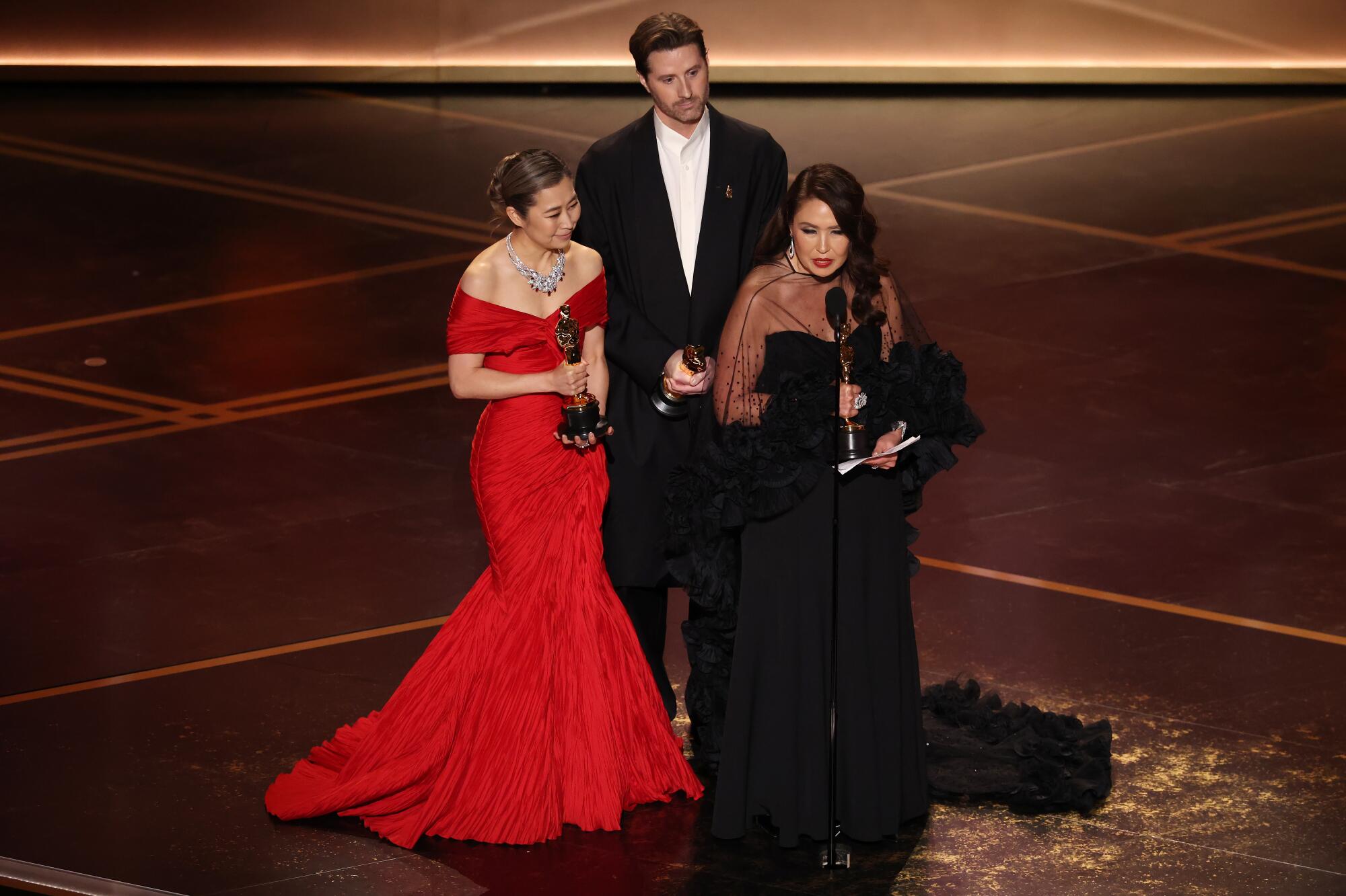 Maggie Kang, Chris Appelhans and Michelle L.M. Wong during the 98th Academy Awards.