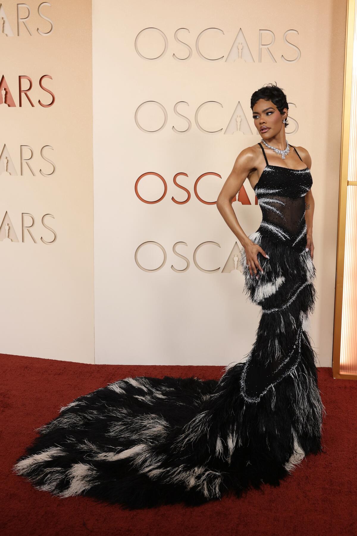 Teyana Taylor arrives in a black and silver gown on the red carpet at the Oscars