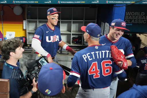 The United States team celebrates after defeating the Dominican Republic at a World Baseball Classic semifinal game, Sunday, March 15, 2026, in Miami. (AP Photo/Lynne Sladky)