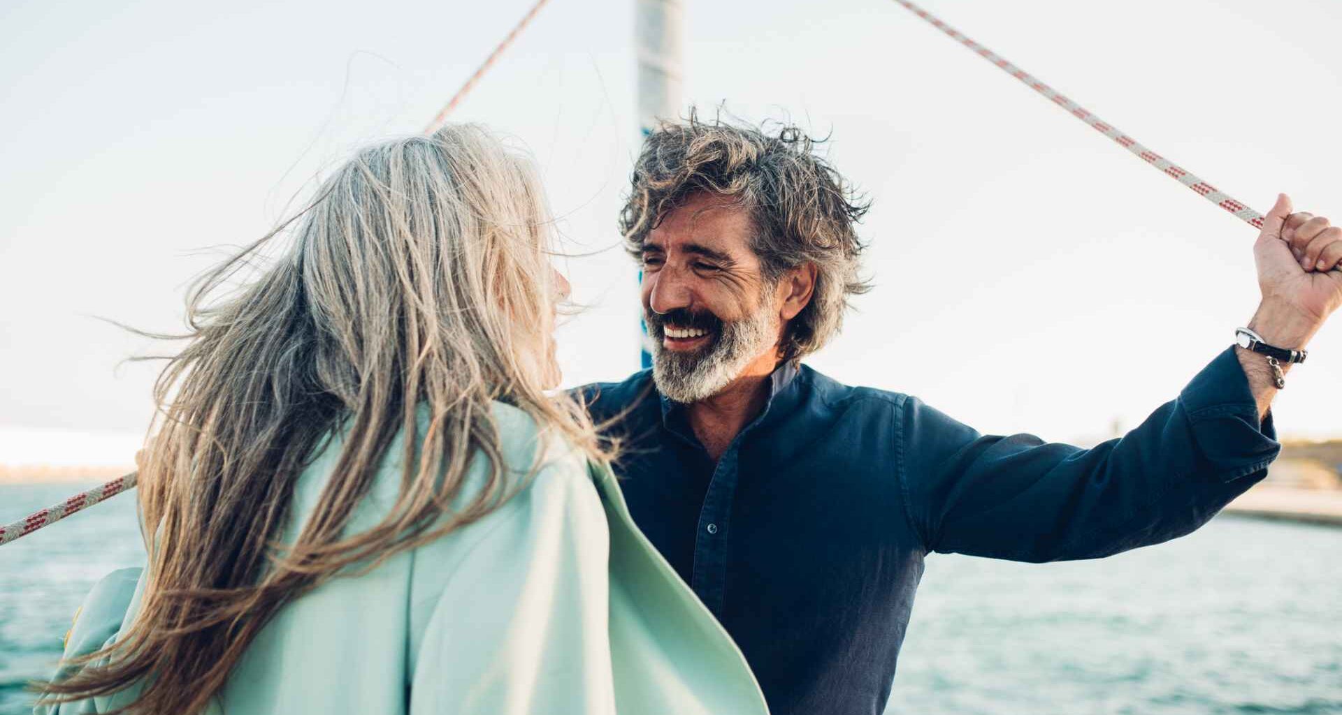 Senior couple in love enjoying cruising on their yacht.