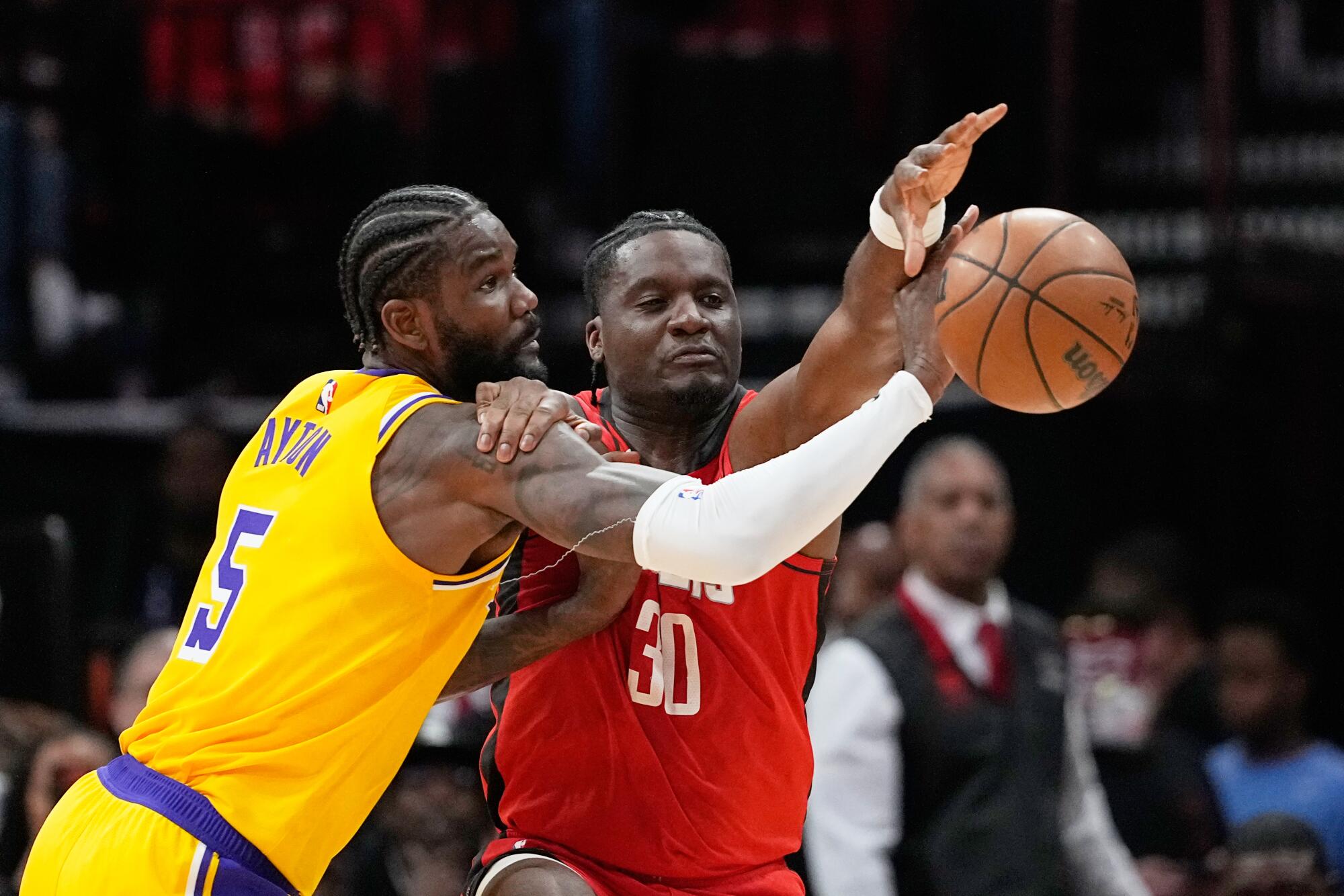 Lakers center Deandre Ayton blocks a pass to Rockets center Clint Capela during their game Monday.