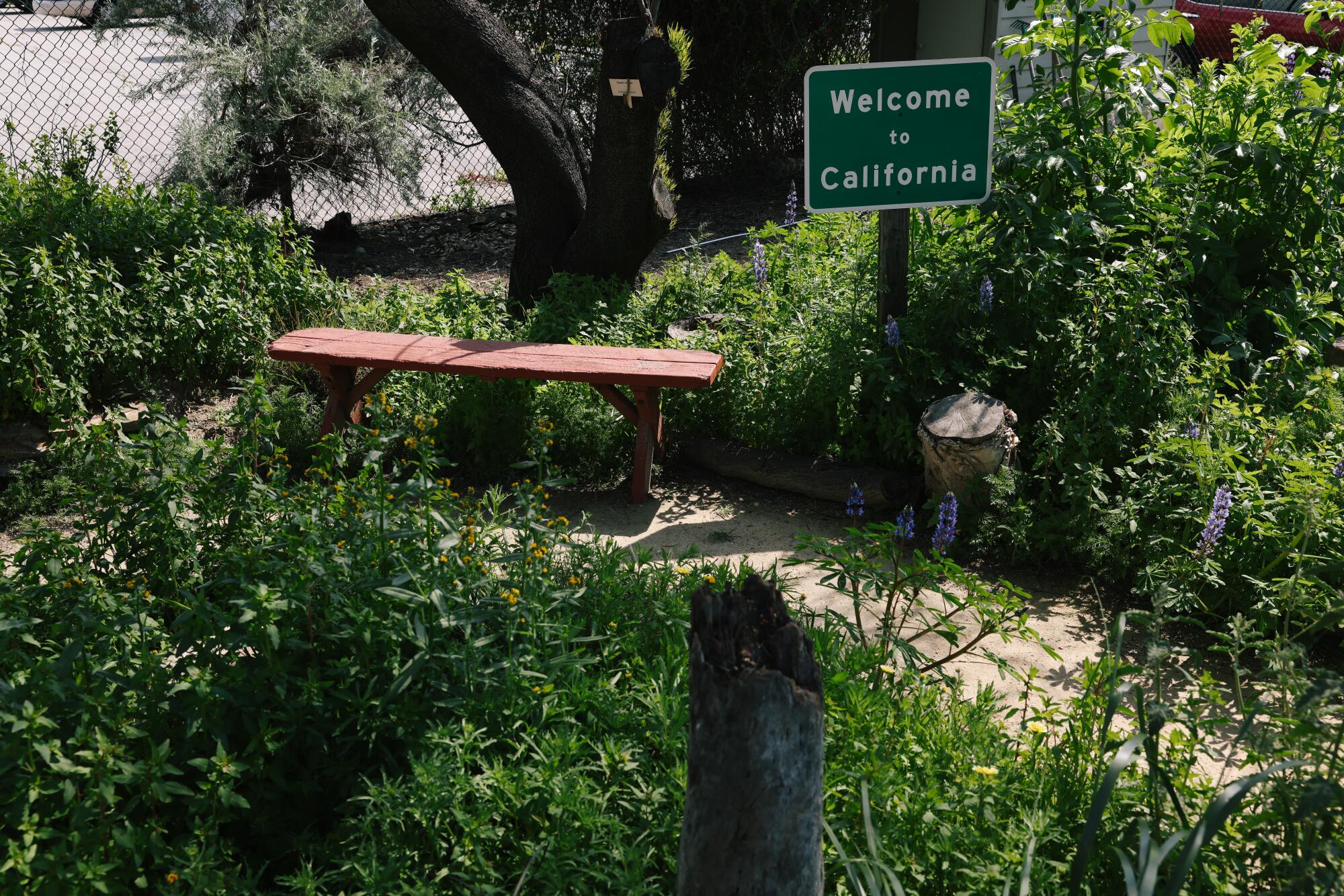 A "Welcome to California" sign is seen at Prisk Native Plant Garden in Long Beach.