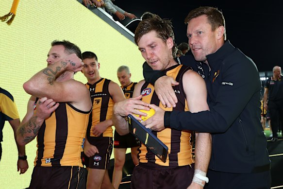 Dylan Moore is embraced by coach Sam Mitchell after overcoming a tumultuous period off the field to shine on it.