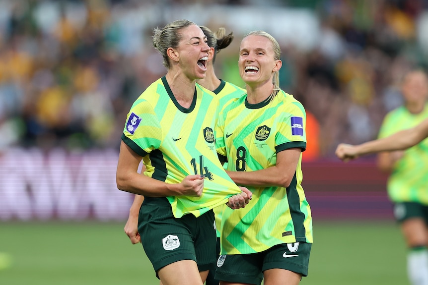 Alanna Kennedy celebrates a goal by tugging her shirt