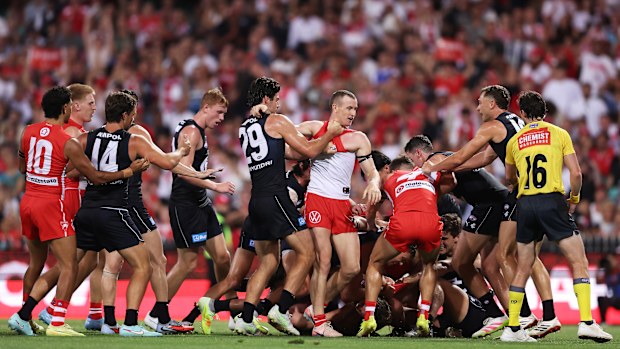 Players wrestle during the opening round AFL match between Sydney Swans and Carlton Blues.