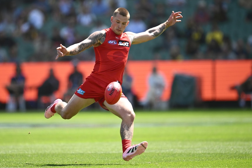 Bailey Humphrey of the Suns about to kick the football long during an AFL match