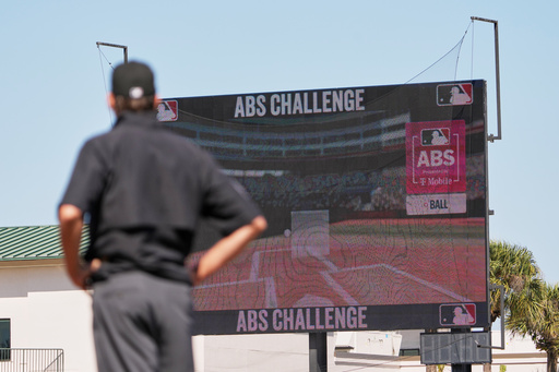 Umpire Ryan Additon watches as a call is challenged using MLB