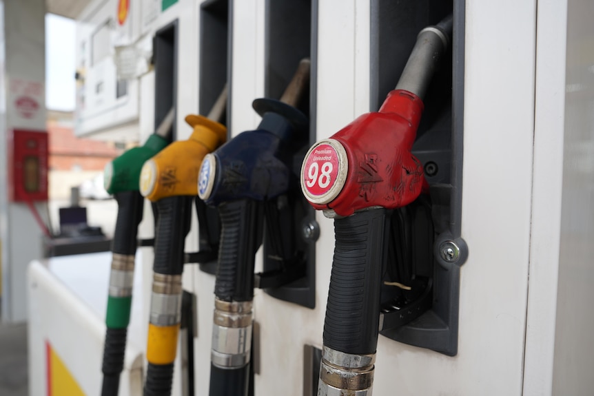 A row of petrol pumps at a service station.