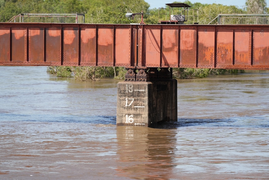 A flood level marker on the bridge shows the river has rise to 16 metres.