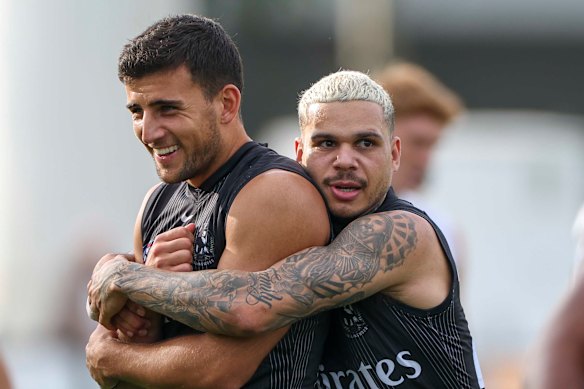 Bobby Hill embraces Nick Daicos at training this week.