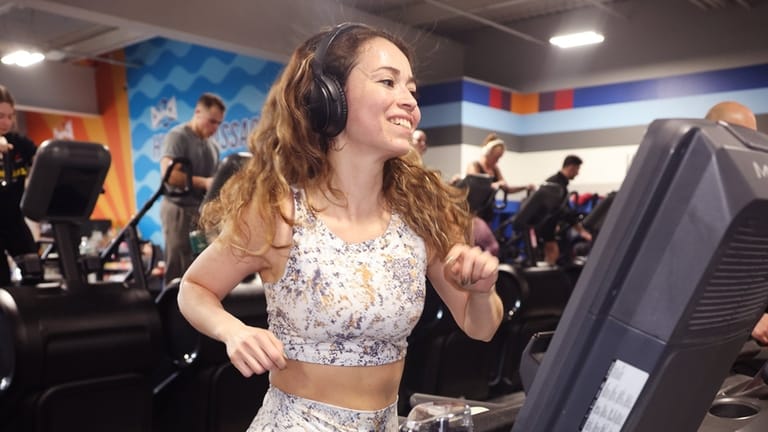 Natalia Posada, of Seaford, exercises after dropping off her son,...