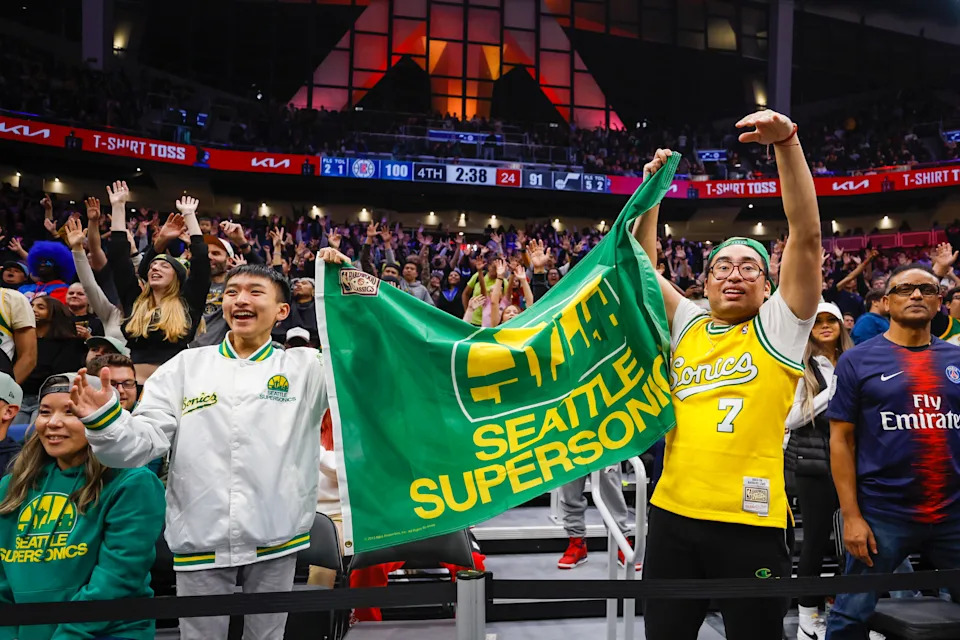 Fans hold a flag for the Seattle Supersonics during the fourth quarter of a game between the Utah Jazz and LA Clippers at Climate Pledge Arena in Seattle on Oct. 10, 2023.