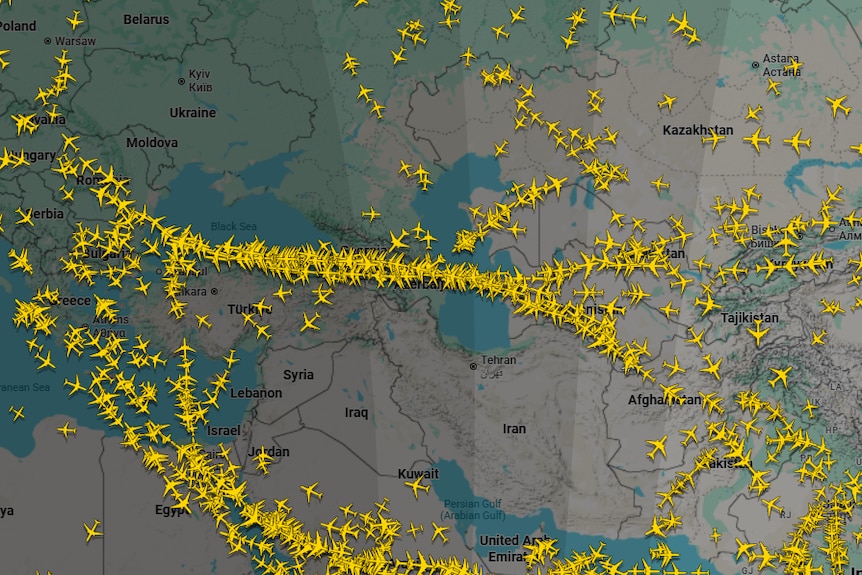 A screenshot of FlightRadar24, showing no planes over the Middle East and Ukraine and lots of flights over Central Asia.