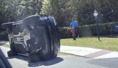 Golfer Tiger Woods stands by his overturned vehicle in Jupiter Island, Fla., on Friday, March 27, 2026. (AP Photo/Jason Oteri)