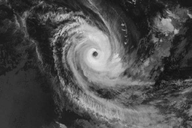 A satellite image of a cyclone with a well-defined eye and a large swirl of clouds.