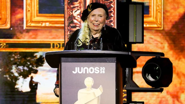 A woman stands on a stage.