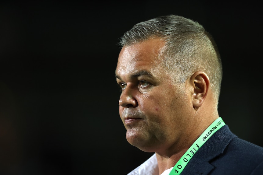 A coach looks on before a rugby league match
