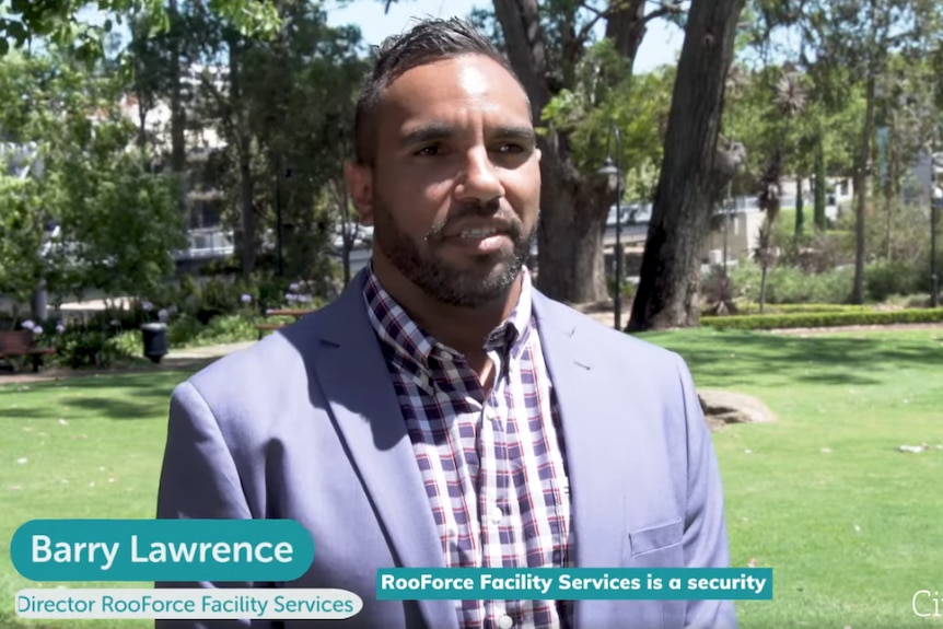 Barry Lawrence in a suit jacket participating in an interview.