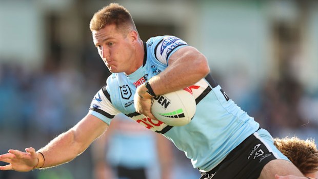 Teig Wilton of the Sharks is tackled.