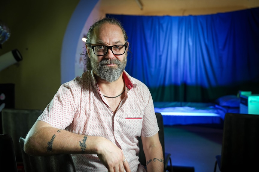Man sitting in front of a stage