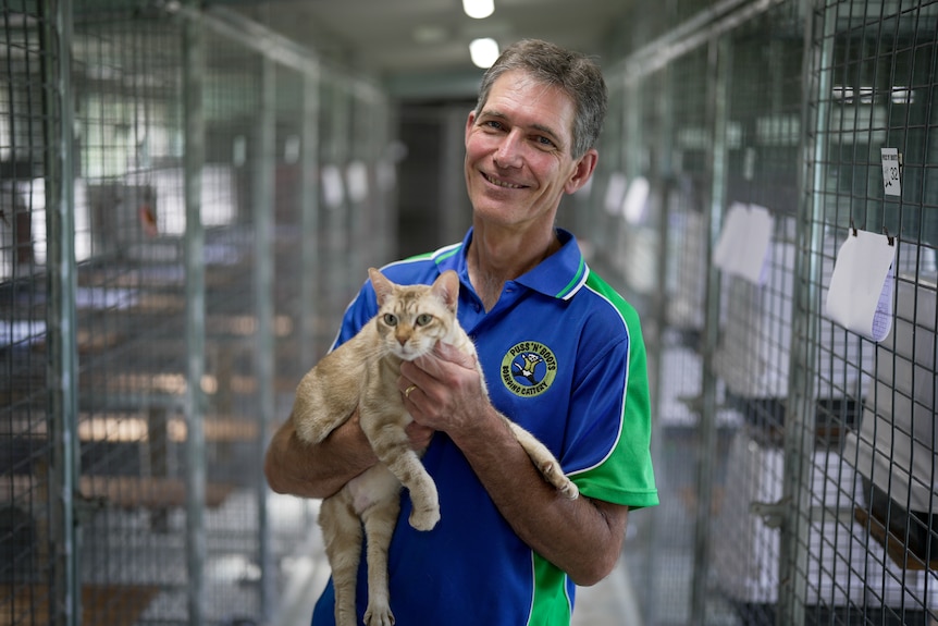A man holding a cat.