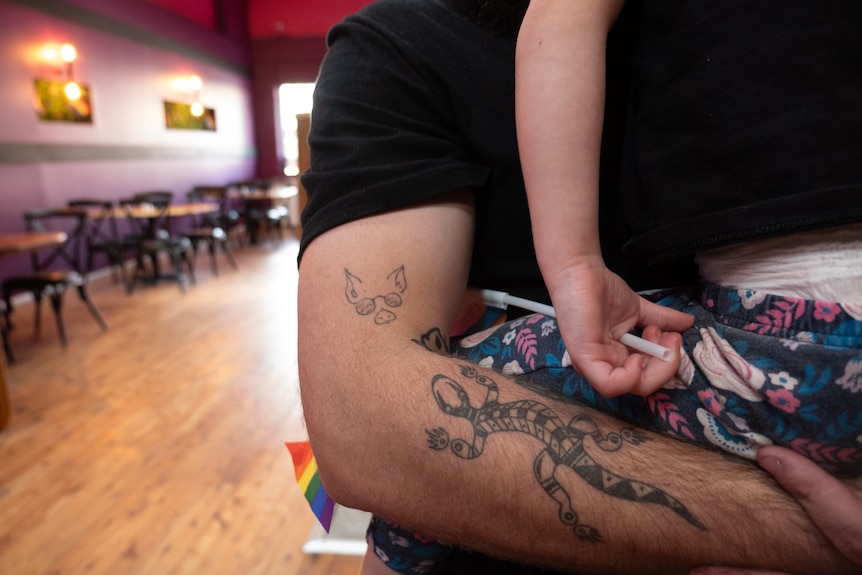 A close up picture of a tattoo on a persons arm showing a pig wearing sunglasses