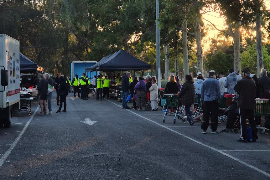 The line of people queueing to access food hampers from Cos We Care.