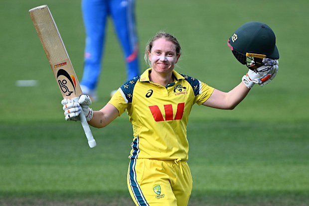 Alyssa Healy celebrates scoring a century against India.