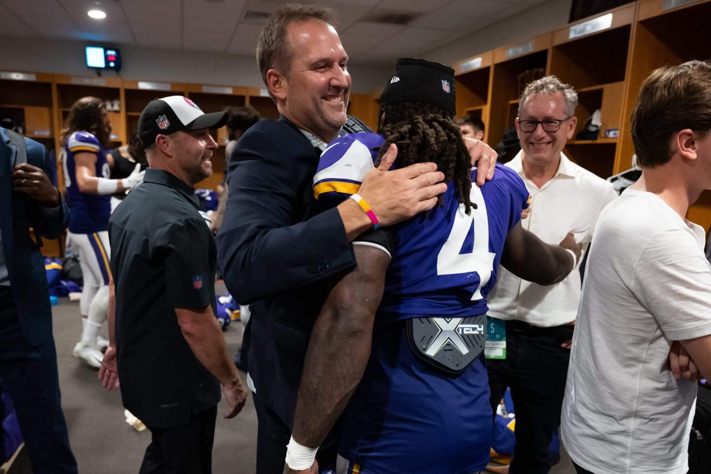 Rob Brzezinski hugs running back Dalvin Cook in the locker room after a win over the Miami Dolphins in 2022.
