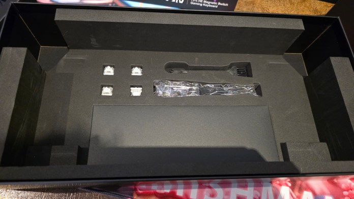 Inside the box with keycap cleaner, keycap puller, four spare keys, and microfiber cloth.