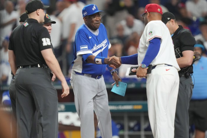 Albert Pujols shakes hands with Dusty Baker at home plate.