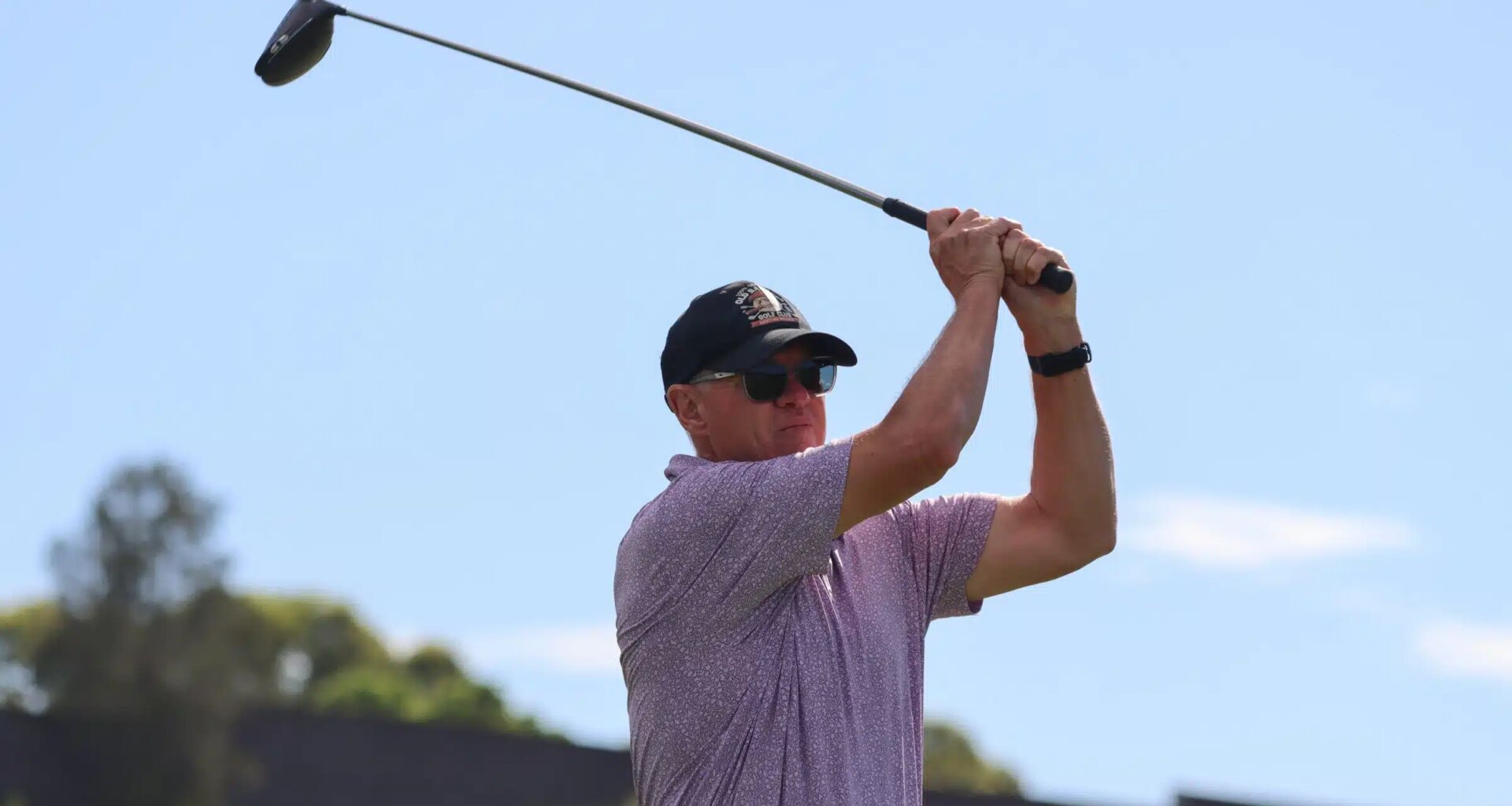 A male teeing off