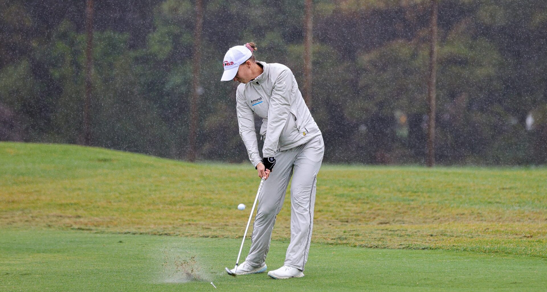 A golfer playing in the rain