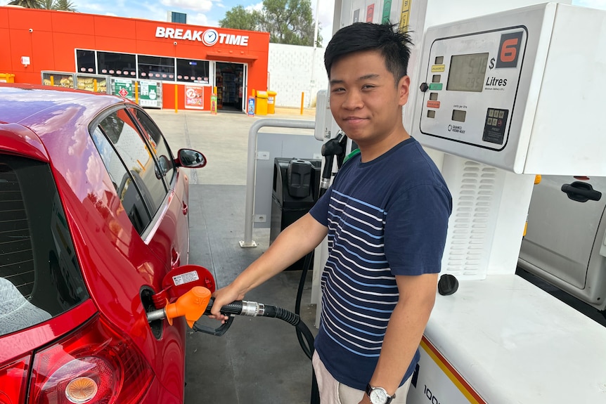 A man filling up his car with fuel