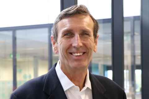 Man wearing business suit smiles at camera