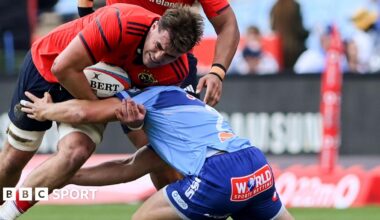 Brian Gleeson of Munster is tackled by Johan Grobbelaar of Bulls