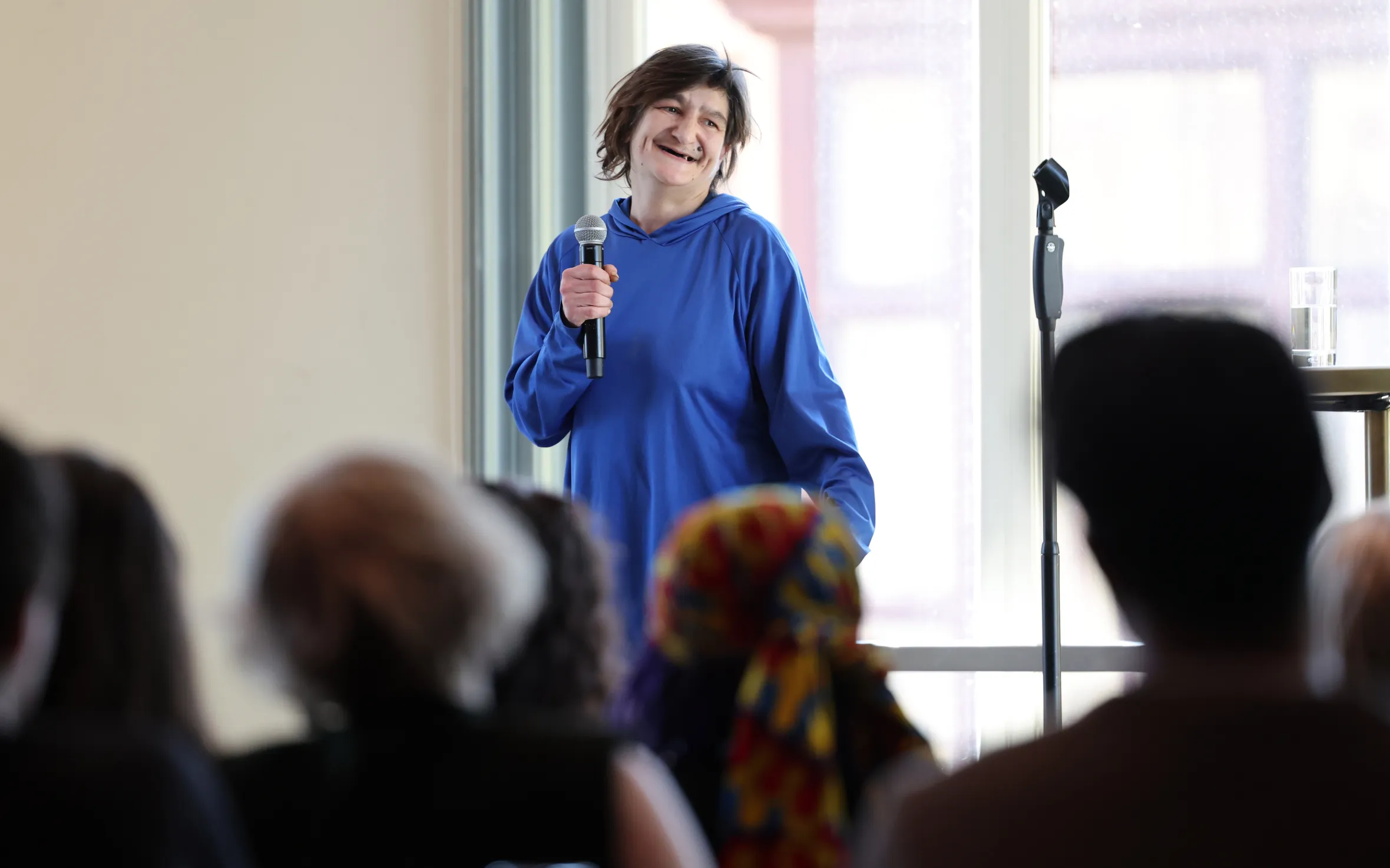 Tracey, a homeless woman, performs stand-up comedy onstage at the Royal Albert Hall.