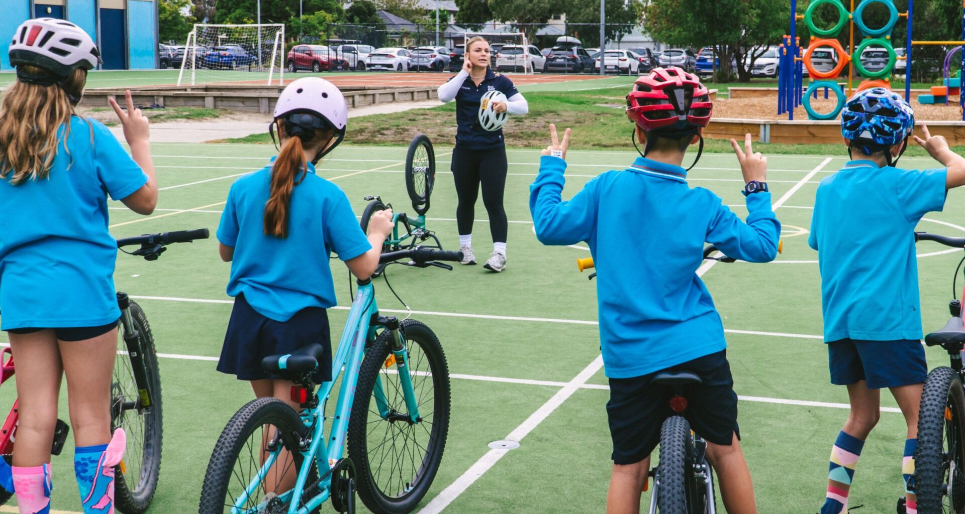 ARA Australian Cycling Team athletes Molly McGill and Ryan Elliott talk to students of St Peter Chanel Primary School as part of Ride2School Day and Brisbane Cycling Festival.