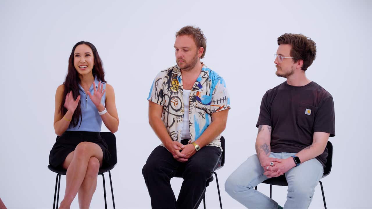 Three influencers - one woman and two men - sit on high chairs in a white studio space 