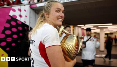 Zoe Stratford carrying the Women's Rugby World Cup trophy