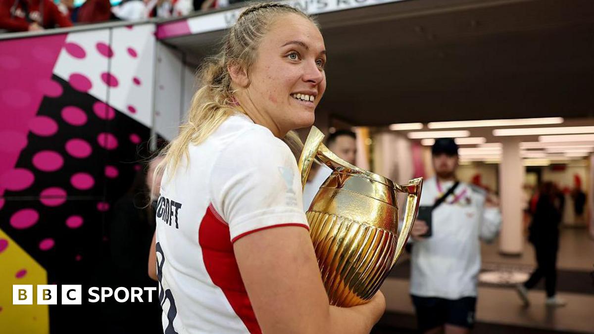 Zoe Stratford carrying the Women's Rugby World Cup trophy