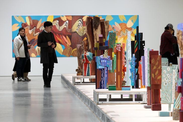 Kim Yun-shin's retrospective at the Hoam Museum of Art closes with a striking final scene: a long, runway-like plinth lined with vividly colored wooden sculptures. Newsis