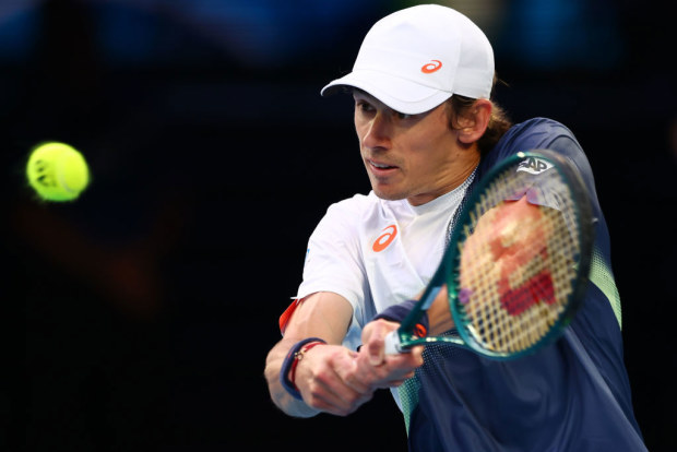 Alex de Minaur of Australia plays a backhand in his charity match against Carlos Alcaraz of Spain.