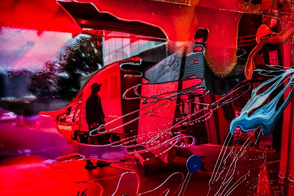 Artist Matthew Cook reflected in the work of Vicki Lee’s Sulman prize entry.