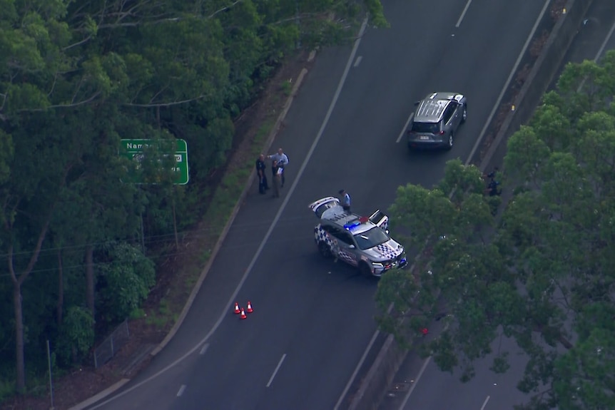 An aerial photo of a police vehicle on a major road.