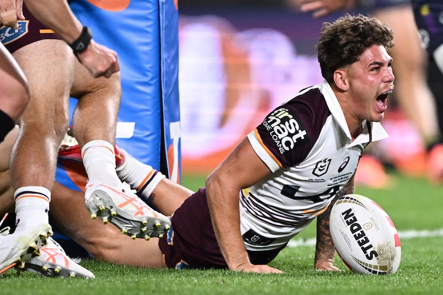 Reece Walsh of the Broncos scores a try during the NRL Grand Final