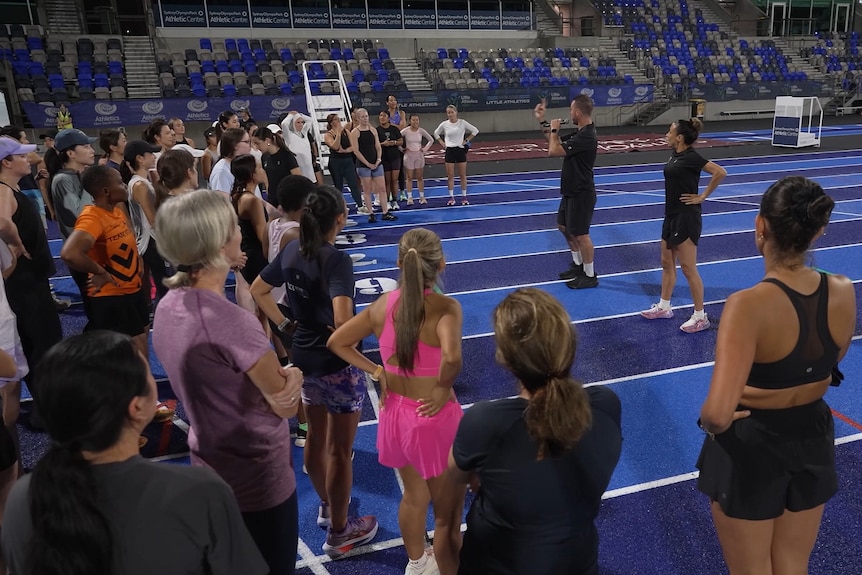 a group of women at a running track in sydney for night time running