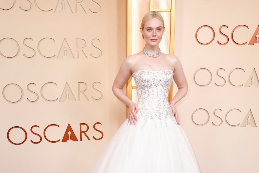 A woman in a low bun with a white gown.
