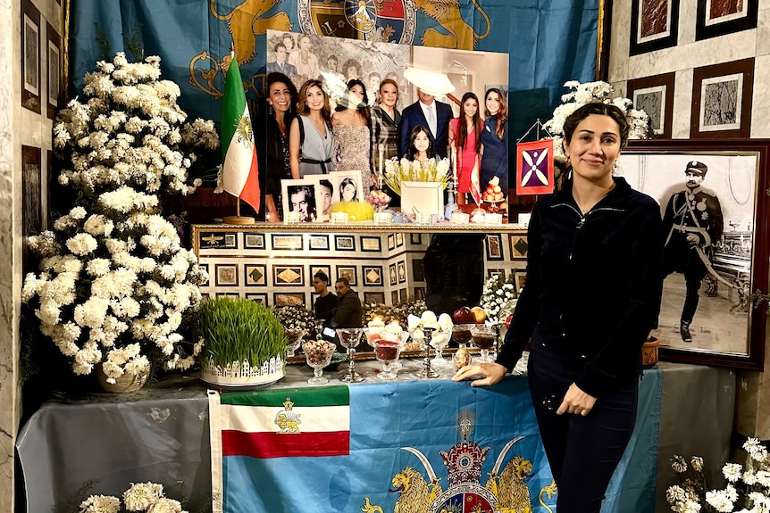 Nasrin Pour is standing in front of a haft seen table when she celebrated Nowruz in Egypt. 
